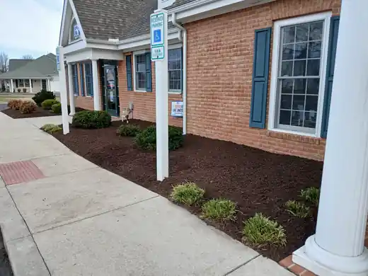 Mulch bed along an office's brick frontage