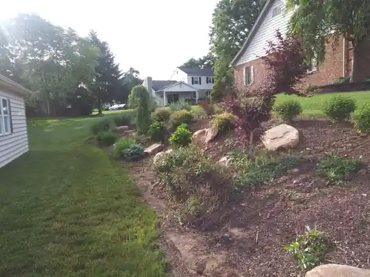 Bed being rebuilt with boulders and new plants