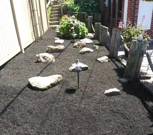 Mulched side yard with stepping stones